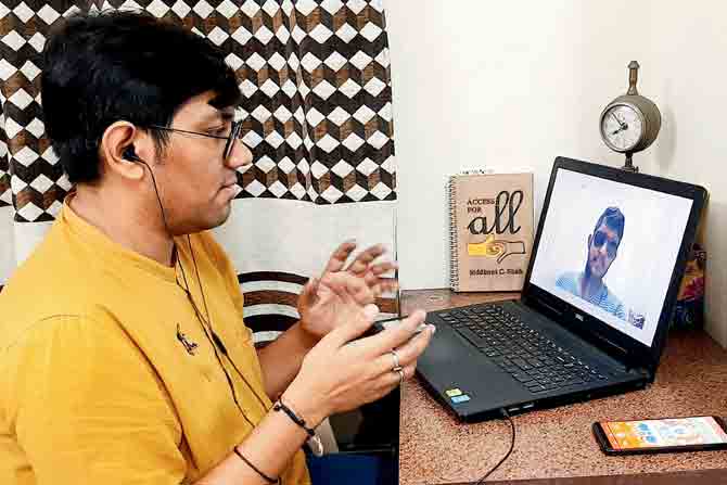 Shah interacting with a hearing impaired youth during lockdown