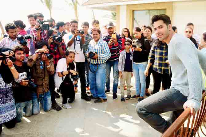 File photo of Varun Dhawan posing for the paparazzi during a promotional event;