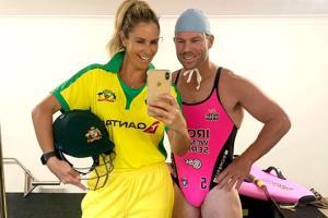 Warner and Candice switch clothes; he wears swimsuit, she wears jersey