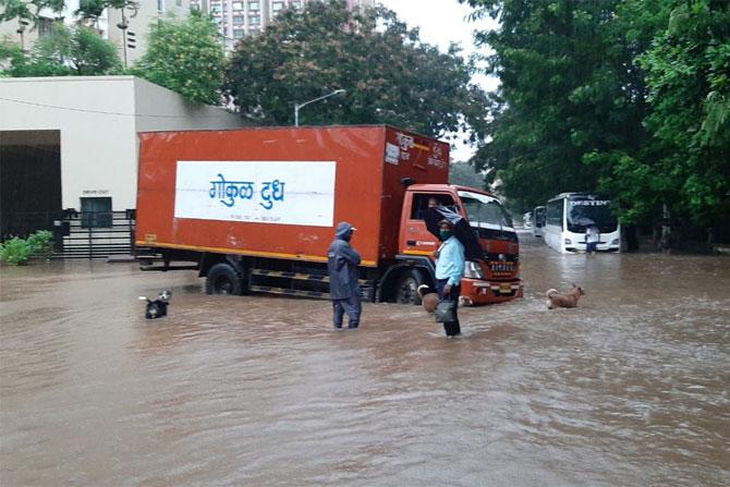 In photo: A milk truck stuck in a drainage hole on the flooded streets of Thakur Village, Kandivli, as heavy rains battered Mumbai.