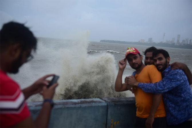 In photo: A group of friends poses for a picture in the backdrop of high tide at Marine Drive in South Mumbai.