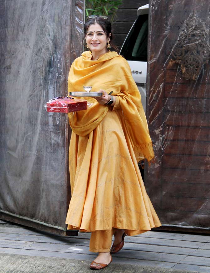 Raveena Tandon was snapped holding a thali for Raksha Bandhan celebration. The popular 90s actress was headed to her brother's residence. All pictures/Yogen Shah