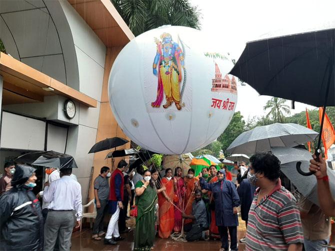 In photo: BJP party members celebrate the laying of the foundation stone by releasing a giant balloon in the air.