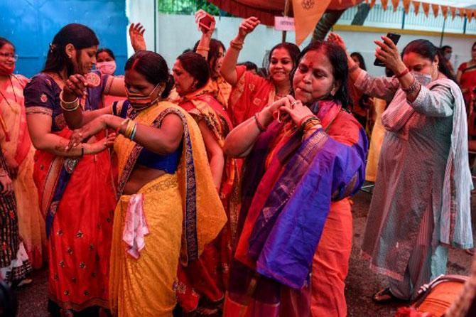 Women activists of the Vishwa Hindu Parishad (VHP) dance outside VHP headquarters in New Delhi, hours before the 'bhoomi pujan'.