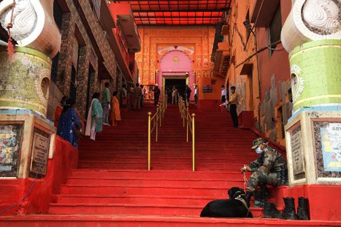In photo: A member of a bomb squad team sits on the staircase at Hanuman Garhi temple, minutes before the arrival of Prime Minister to offer prayers.