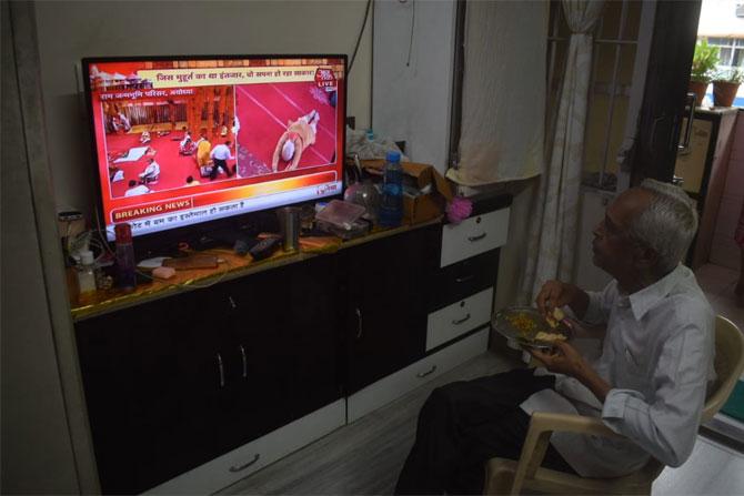In photo: A senior citizen watches the ceremony for the construction of Ram Mandir live on TV at his home in Mumbai.