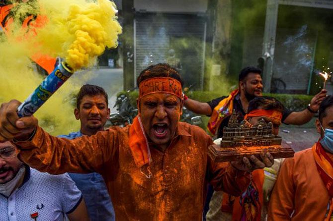 BJP activists and supporters shout slogans as part of celebrations, in New Delhi.
