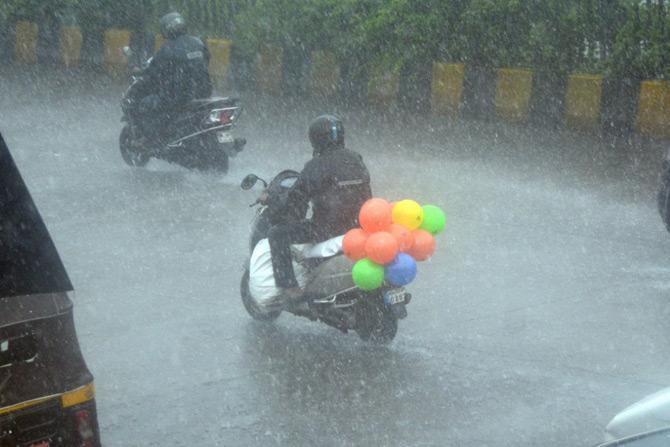 In picture: A motorist rides on a two-wheeler with balloons tied on his back seat, in Saath Rasta near Arthur Road Jail.
