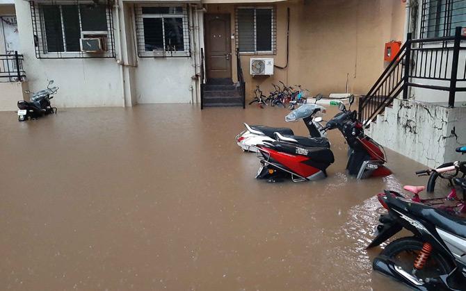 In picture: Vehicles parked in a residential building compound submerged in Thakur Village, Kandivli.