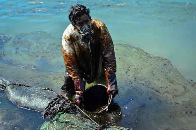 As of August 13, nearly all the 3,000 tonnes of fuel left on the MV Wakashio has been emptied from the vessel stranded on a coral reef at Pointe d'Esny, a sanctuary for rare wildlife, the shipowners said.
In picture: A man scoops leaked oil from vessel MV Wakashio, that ran aground near Blue Bay Marine Park off the coast of south-east Mauritius.