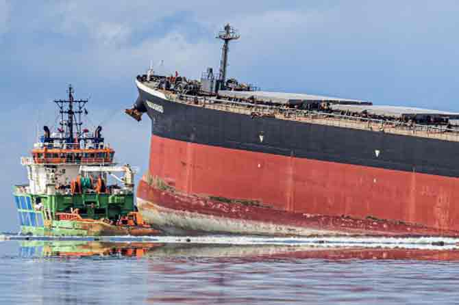 Owner Nagashiki Shipping said in a statement that 'residual' amounts of fuel remain on the ship. The company has sent experts to help in cleaning up the damage. “We will continue to do our utmost to minimize the impact of oil spill recovery and environmental pollution,” said representative director Kiyoaki Nagashiki.
In picture: Workers look on from a ship near vessel MV Wakashio.