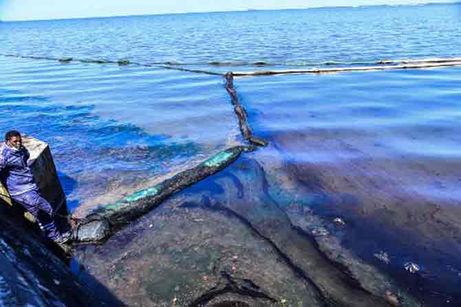 Some of the turquoise waters surrounding Mauritius were stained muddy black, fouling mangrove wetlands and drenching waterbirds and reptiles with sticky oil.
In picture: A Mauritius Army personnel stands next to the handmade oil barrier trapping leaked oil from the MV Wakashio bulk carrier that had run aground at the beach in Mahebourg, southeast Mauritius.
