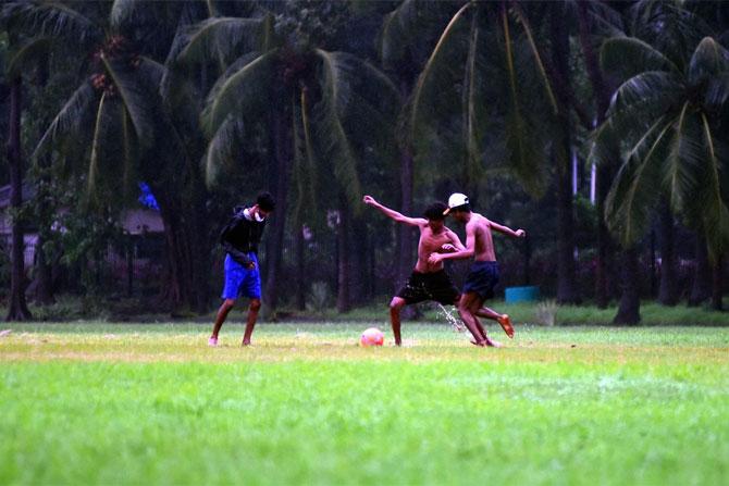 In photo: A group of young boys snapped while playing football at the Oval ground in Churchgate.