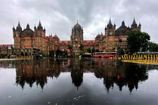 In photo: A reflection of Chhatrapati Shivaji Maharaj Terminus (CSMT) can be seen on the waterlogged road after rains hit several parts of Mumbai.