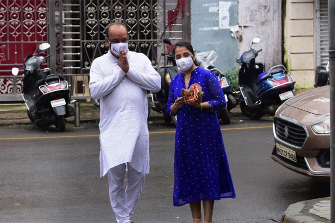 In photo: A family waits for an idol maker to arrive with the Ganpati idol.