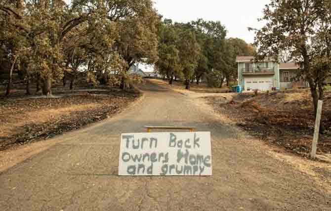 Over the last week, California has been hit by 650 wildfires across the state, many sparked by more than 12,000 lightning strikes recorded since August 15. Over 14,000 firefighters. 2,400 engines and 95 aircrafts have been battling the fires.
In picture: A sign asking for privacy is put up in the middle of a street in Bucktown, California.