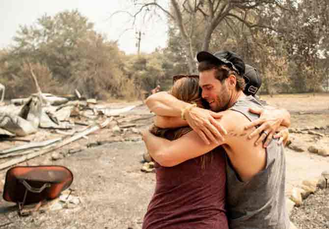 In picture: A resident cries while hugging a family member after seeing the burned remains of their home in Vacaville.