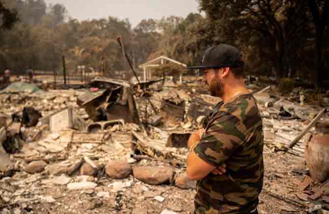 More than 1,200 buildings have been destroyed. The number is bound to increase as residents are allowed back into neighborhoods and inspectors get a better look.
In picture: A resident looks over the charred remains of his family home in Vacaville, California. 