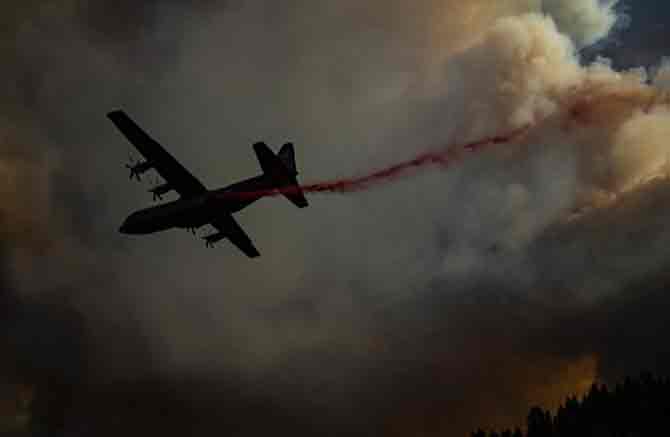 Helicopters dropped more than 200000 gallons (over 757,082 litres) of water on the blaze to put out the fire.
In picture: An aircraft drops fire retardant on a ridge during the Walbridge fire, part of the larger LNU Lightning Complex fire as flames continued to spread in Healdsburg, California.