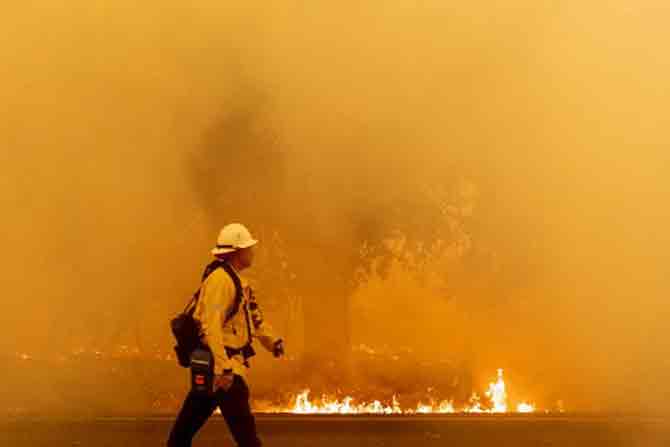 Three massive wildfires chewed through parched Northern California landscape as firefighters raced to dig breaks and make other preparations ahead of a frightening weather system packing high winds and more of the lightning that sparked the huge blazes.