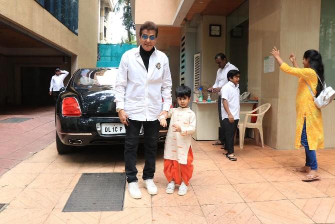 Veteran actor Jeetendra opted for a white shirt and black pants, while his grandson Laksshya looked cute in his traditional cream-coloured kurta, orange dhoti and protective white mask.