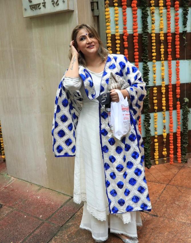 Urvashi Dholakia was all smiles as she posed for the pictures at the producer's residence. She looked ravishing in her white traditional attire. To complete her look, she opted for blue-and-white dupatta and silver sandals.