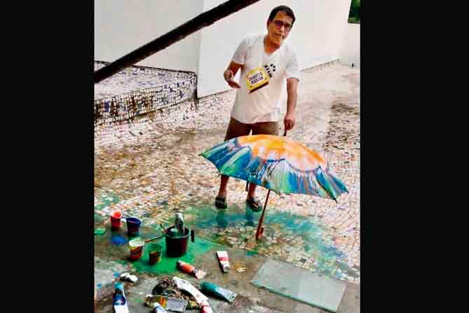 Achyut Palat with an umbrella he painted at the workshop