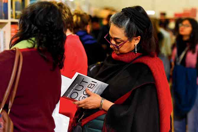 A visitor reads a book during the third day of JLF this year. PIC/GETTY IMAGES 