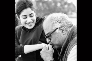 Boney Kapoor plants a kiss on Janhvi's hand as she looks on happily