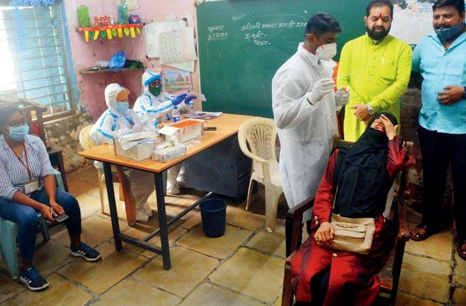 Residents of Ambedkar Nagar near Andheri Kurla Road get tested on Tuesday