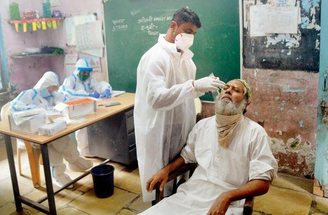 Residents of Ambedkar Nagar near Andheri Kurla Road get tested on Tuesday.