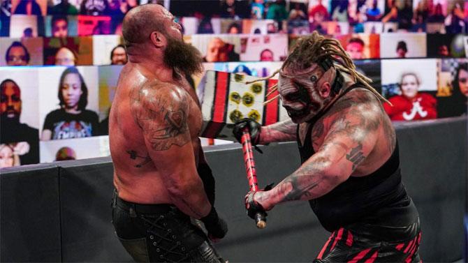 The Fiend Bray Wyatt and Braun Strowman fight at ringside