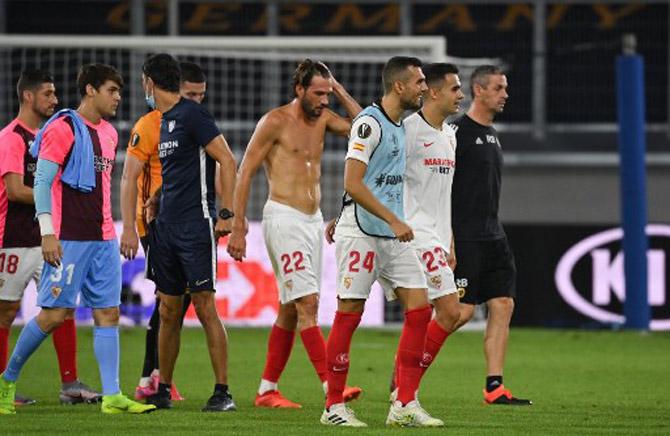 Sevilla players walk off the pitch after the UEFA Europa League quarter-final football match Wolverhampton Wanderers v Sevilla at the MSV Arena on August 11, 2020