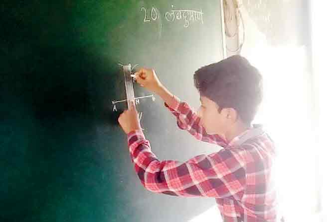 a student draws a maths diagram on the board