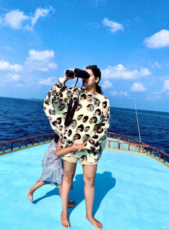 A lovely candid photo here shows Gracia playing around while mom Priyanka Raina checks out the lovely scenery with her binoculars.