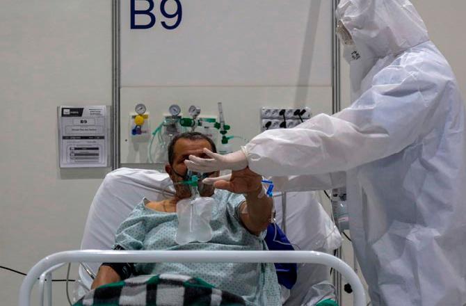 January 30: COVID-19 declared as public health emergency- A health worker performs a physiotherapy treatment on a COVID-19-infected patient at the intensive care unit of Anhembi emergency makeshift hospital in Sao Paulo, Brazil.