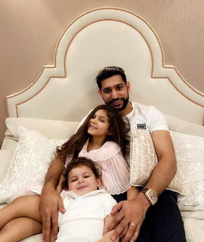 In picture: Amir Khan with his daughters Lamaisah and Alayna at home.