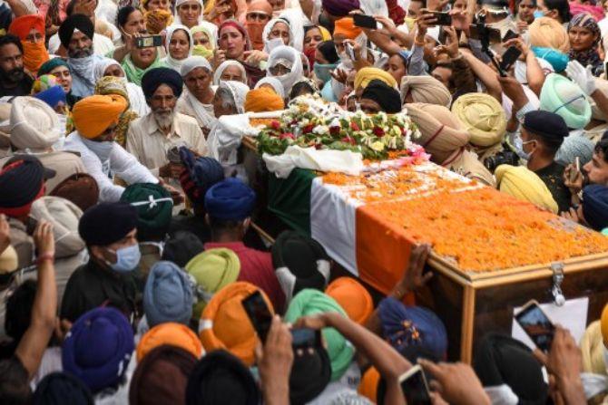 June 15: Galwan valley clash- At least 20 Indian soldiers and over 40 Chinese forces were killed or injured in skirmishes in the disputed Galwan Valley, the largest escalation along the Sino-Indian border in five decades. (In Pic) Family members and villagers carry the coffin of soldier Satnam Singh who was was killed in a recent clash with Chinese forces in the Galwan valley area, during the cremation ceremony at Bhojraj village near Gurdaspur on June 18, 2020. 