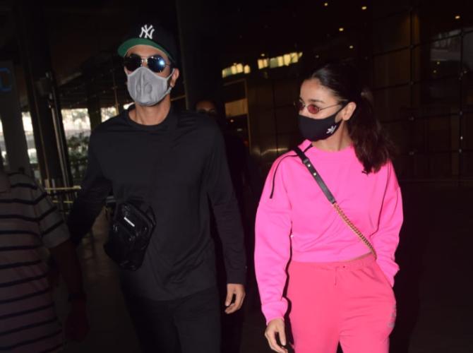 Ranbir Kapoor was clicked with his alleged girlfriend Alia Bhatt at the Mumbai Airport. For the outing, Alia opted for a pink top and trousers while Ranbir donned a black t-shirt and pants. The duo wore protective masks to prevent the spread of COVID-19. (All pictures: Yogen Shah).