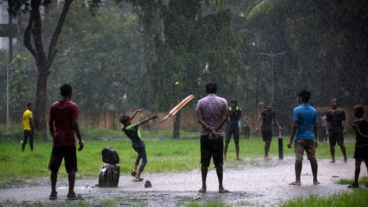 Children playing cricket at a ground in Antop Hill amid heavy rains in Mumbai.
Photo: Atul Kamble