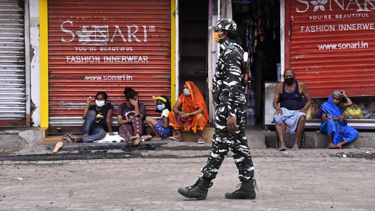 A CRPF jawan keeps a close watch on the movement of people in Dharavi, Asia's largest slum, during the lockdown in Mumbai.
Photo: Pradeep Dhivar