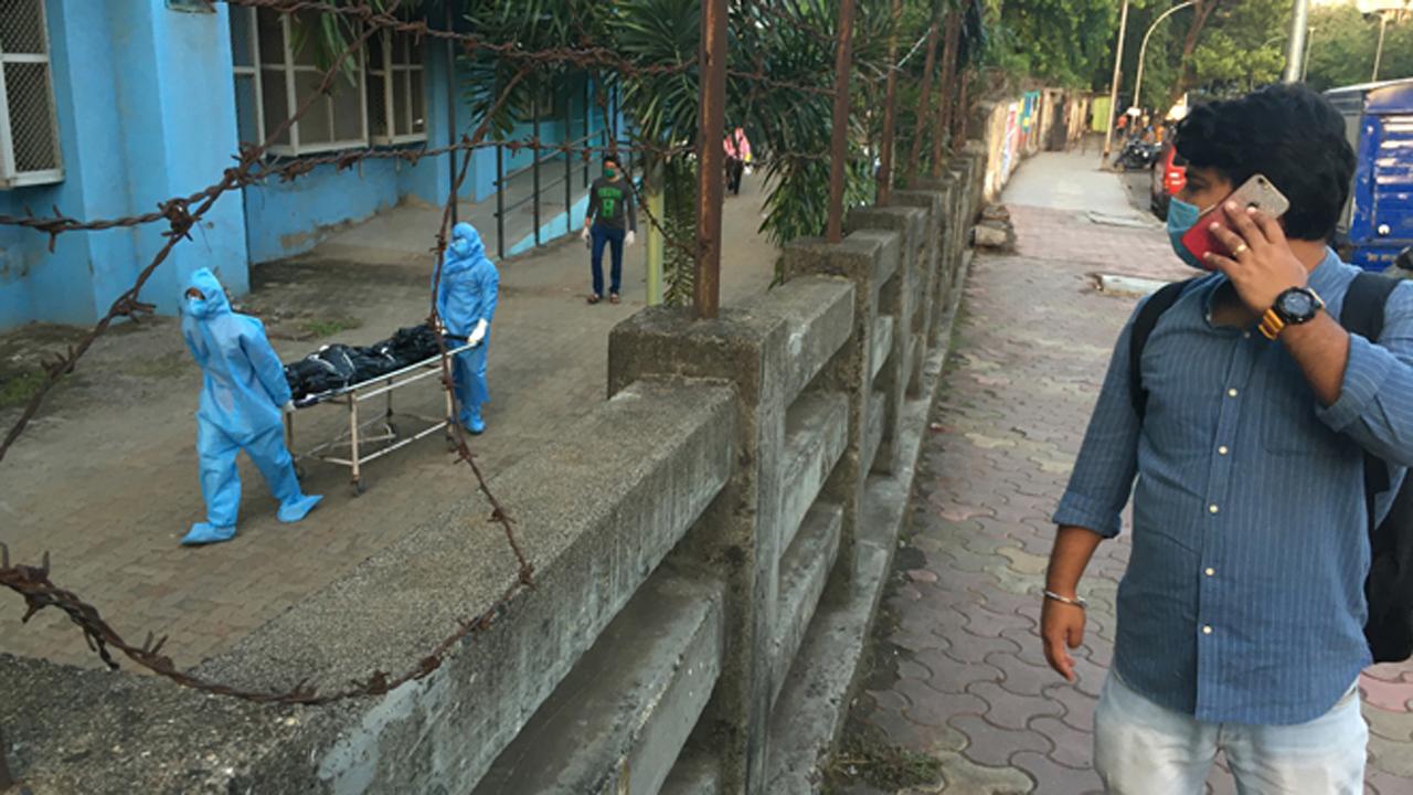 Healthcare workers take the body of a COVID-19 victim to the mortuary.
