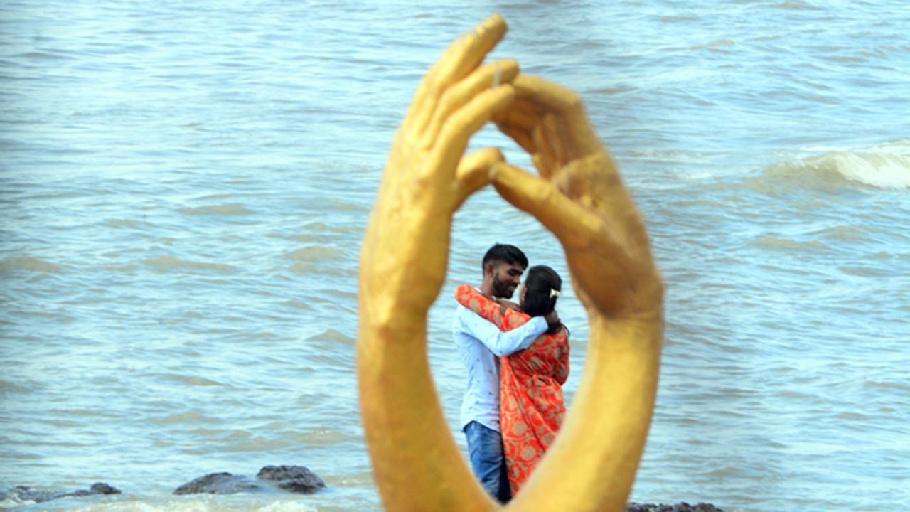 A couple shares a moment outlined by the popular hand sculpture at Bandra's Bandstand.
Photo: Ashish Rane