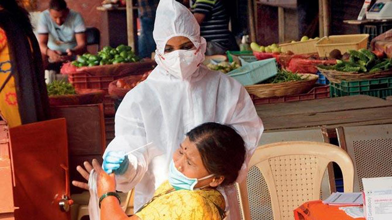 A BMC health official conducts an antigen test of street vendors at Samta Nagar in Kandivli.
Photo: Satej Shinde
