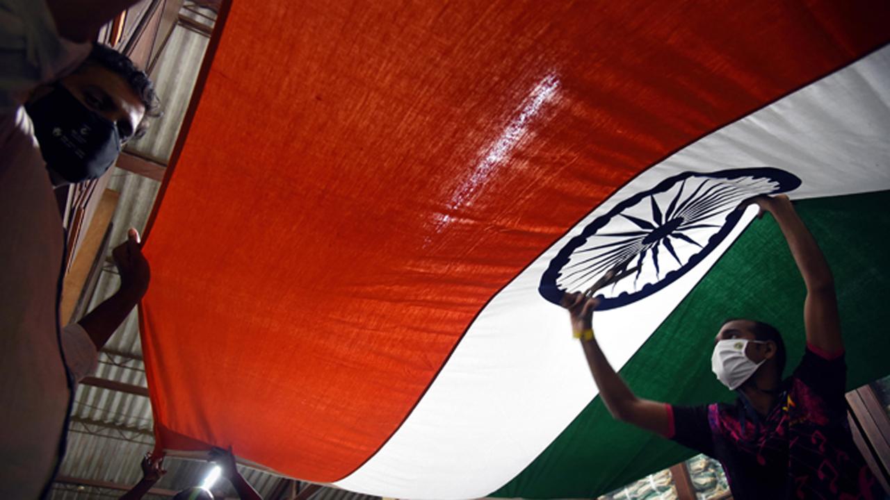 Workers at Kora Kendra Khadi Gram Udyog in Borivali give final touches to the Indian Tricolour ahead of the 74th Independence Day celebrations in Mumbai.
Photo: Nimesh Dave