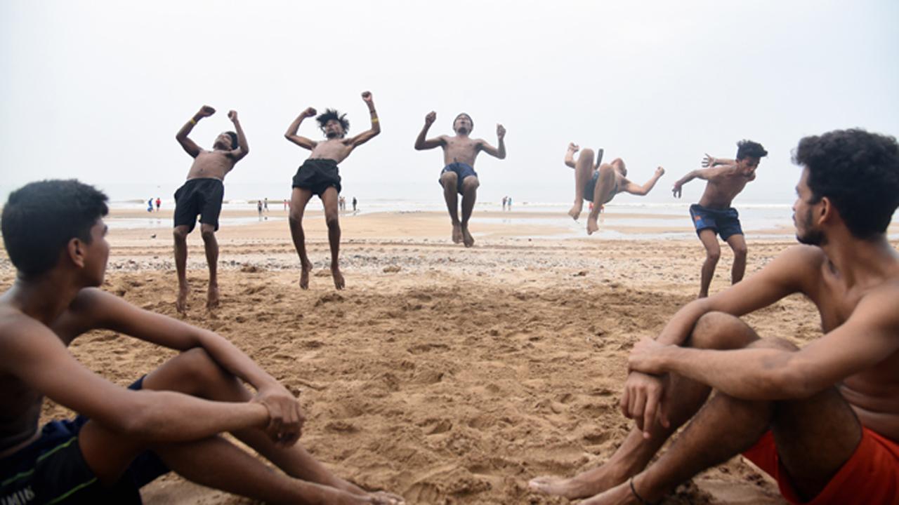 Youngsters perform acrobatic flips during a dance practice session at Juhu Chowpatty.
Photo: Sameer Markande