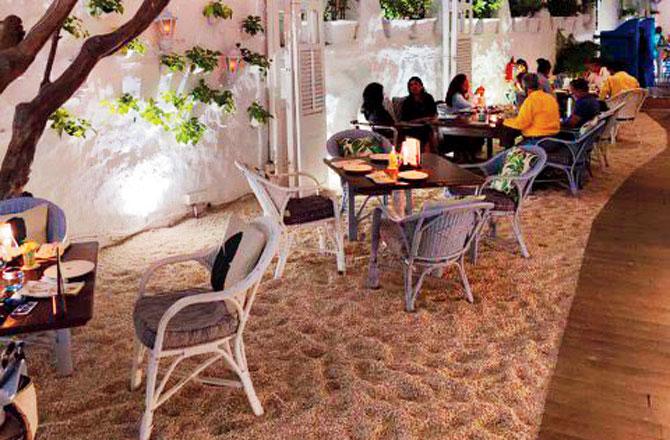 The sidewalk outside the original restaurant has been used for outdoor seating, with staff keeping an eight-feet distance and taking orders from behind barriers