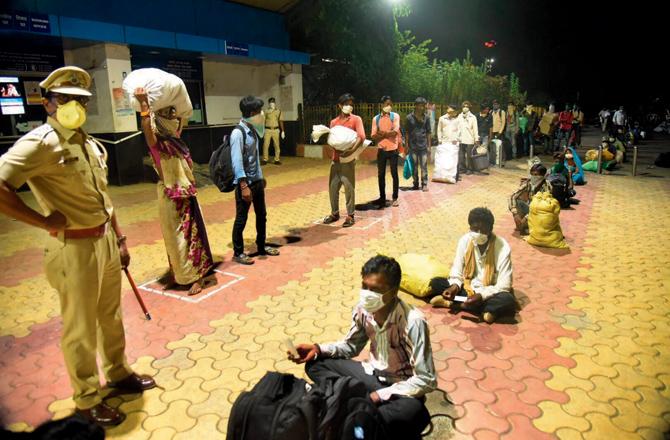 Passengers wait at the Panvel railway station. File pics
