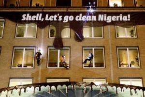 Climate activists attach a banner to the Shell headquarters in The Hague, Netherlands. Pic/AP