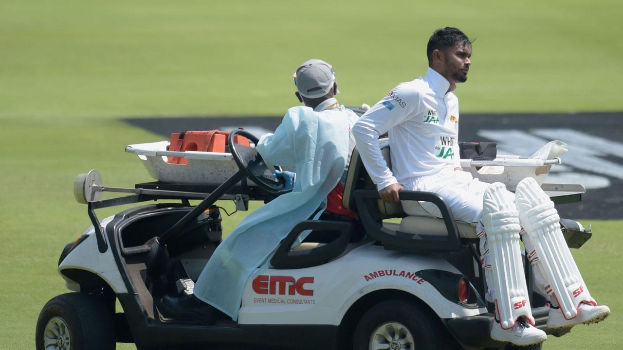 Sri Lanka`s Dhananjaya de Silva (R) is helped off the field by medical staff after being injured during the first day of the first Test cricket match between South Africa and Sri Lanka at SuperSport Park in Centurion. Pic/AFP